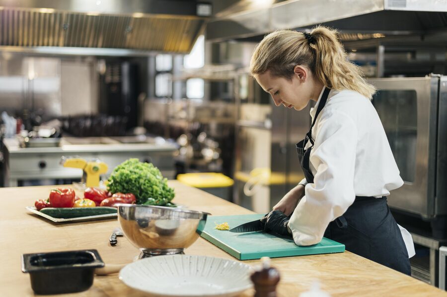 A carer preparing food safely in a kitchen